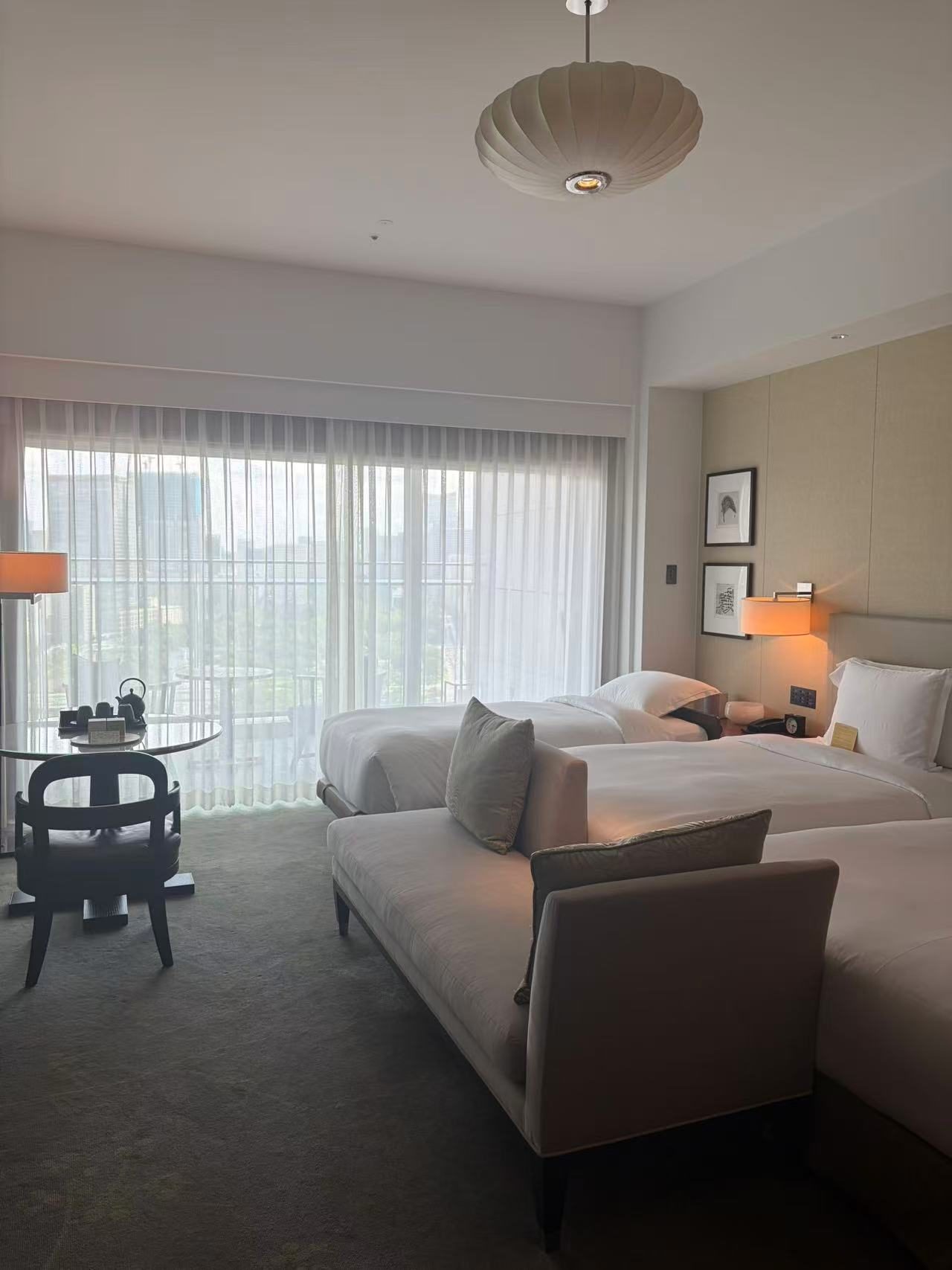 A hotel room laid out with one bed and a separate sofa along the opposite wall.