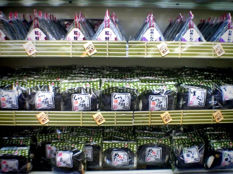 Shelves of packaged rice balls in a Japanese convenience store.