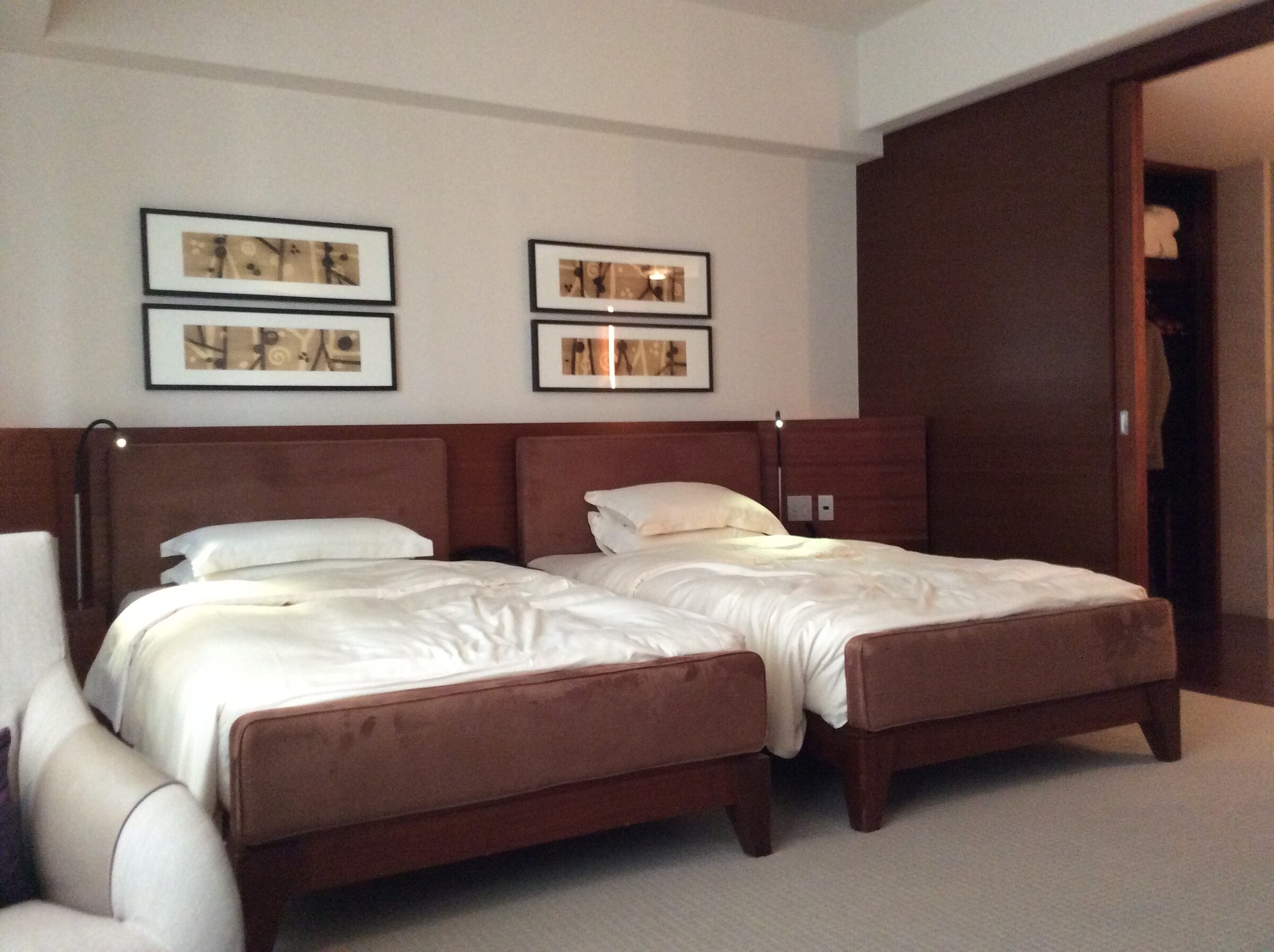 A hotel room in Osaka with two single beds side by side.